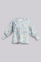 Flat lay of the reistor Relaxed-fit Shirt with Drawstring in Animal Print, featuring a light blue pattern and gathered sleeves on a neutral background.