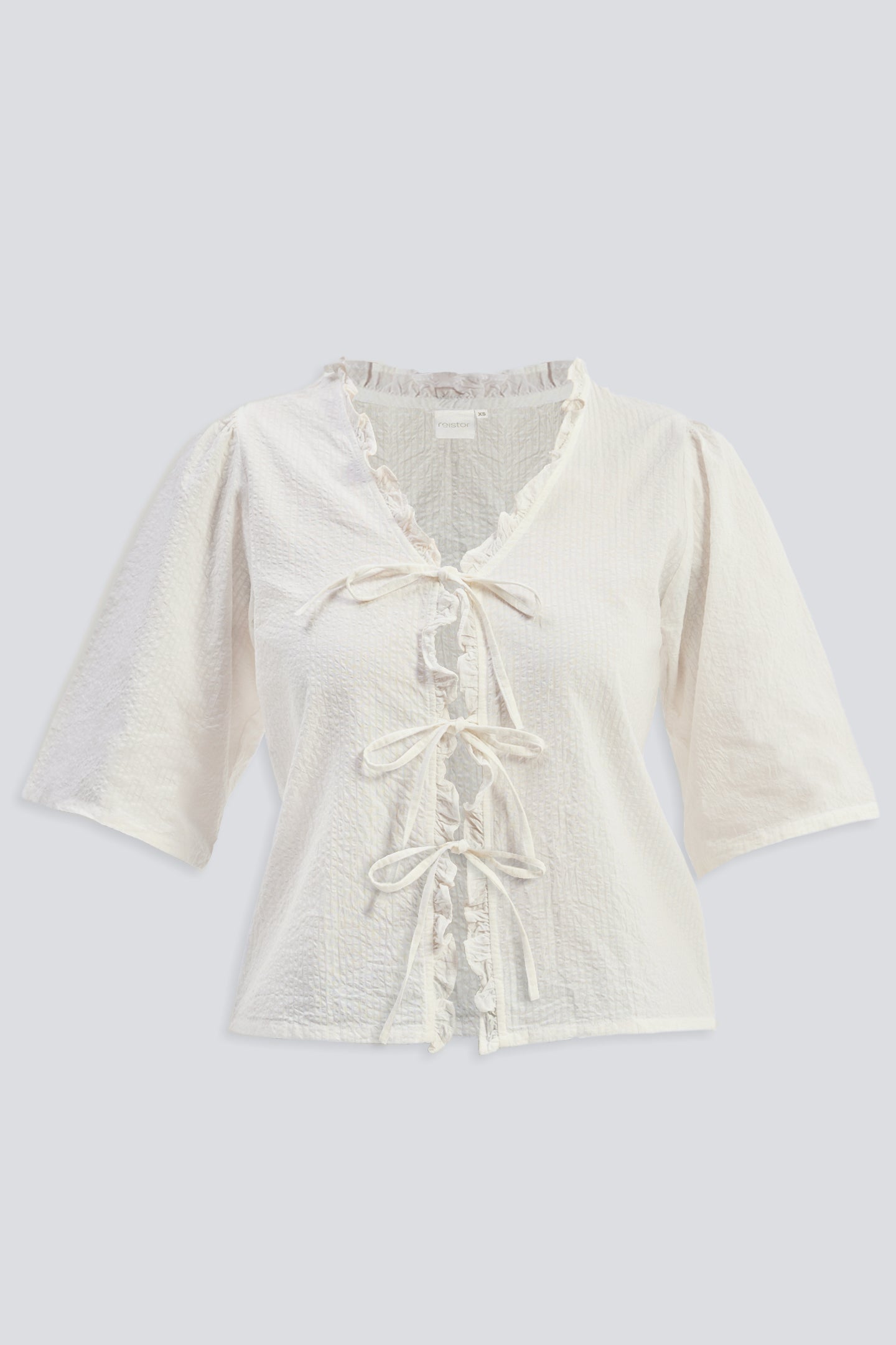 Relaxed Fit Top With Ruffles and Front-Ties in Cream Flat Lay
