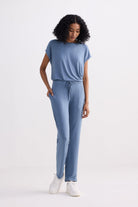 A full-length front view of a model wearing the reistor Relaxed Tee Set in Blue, featuring a soft short-sleeve crew neck top and matching straight-leg drawstring trousers.