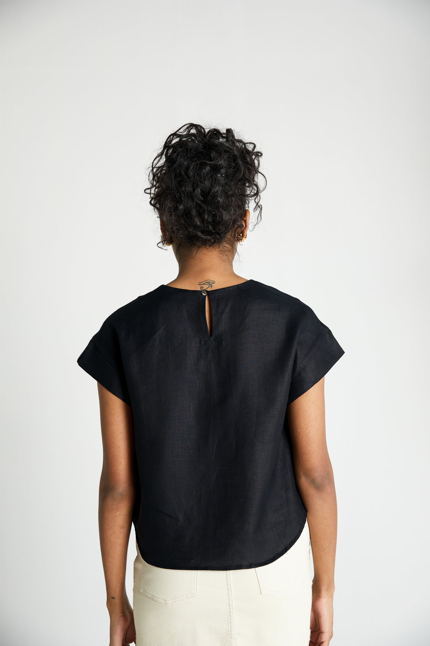 Reistor Sandcastle Saturdays Top in Black, sustainable women's cap sleeve top with a back keyhole detail, breathable fabric, and relaxed everyday fit.
