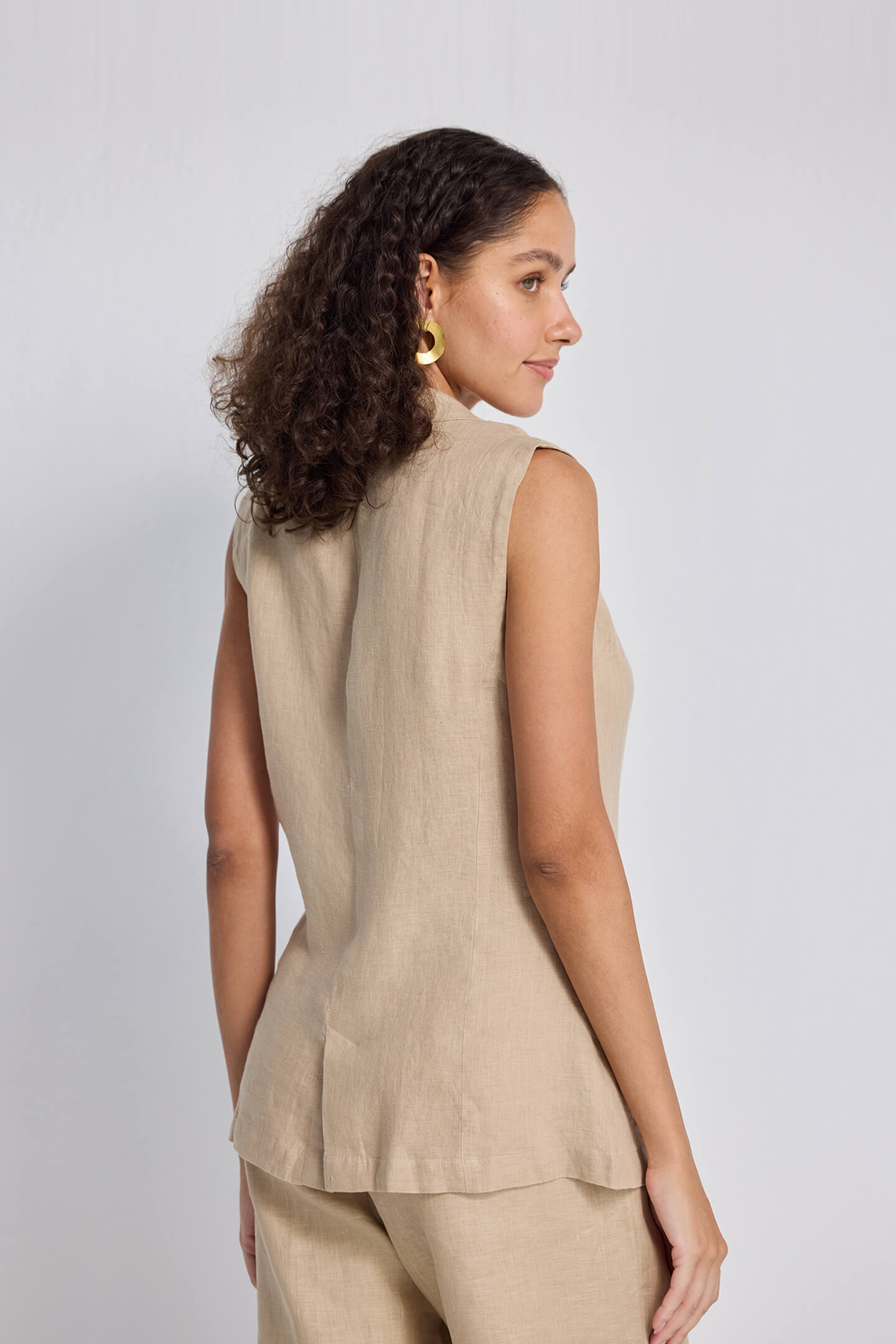 Sleeveless Hemp Jacket by Reistor, beige hemp sleeveless jacket worn by model, relaxed fit with minimalist design and back view