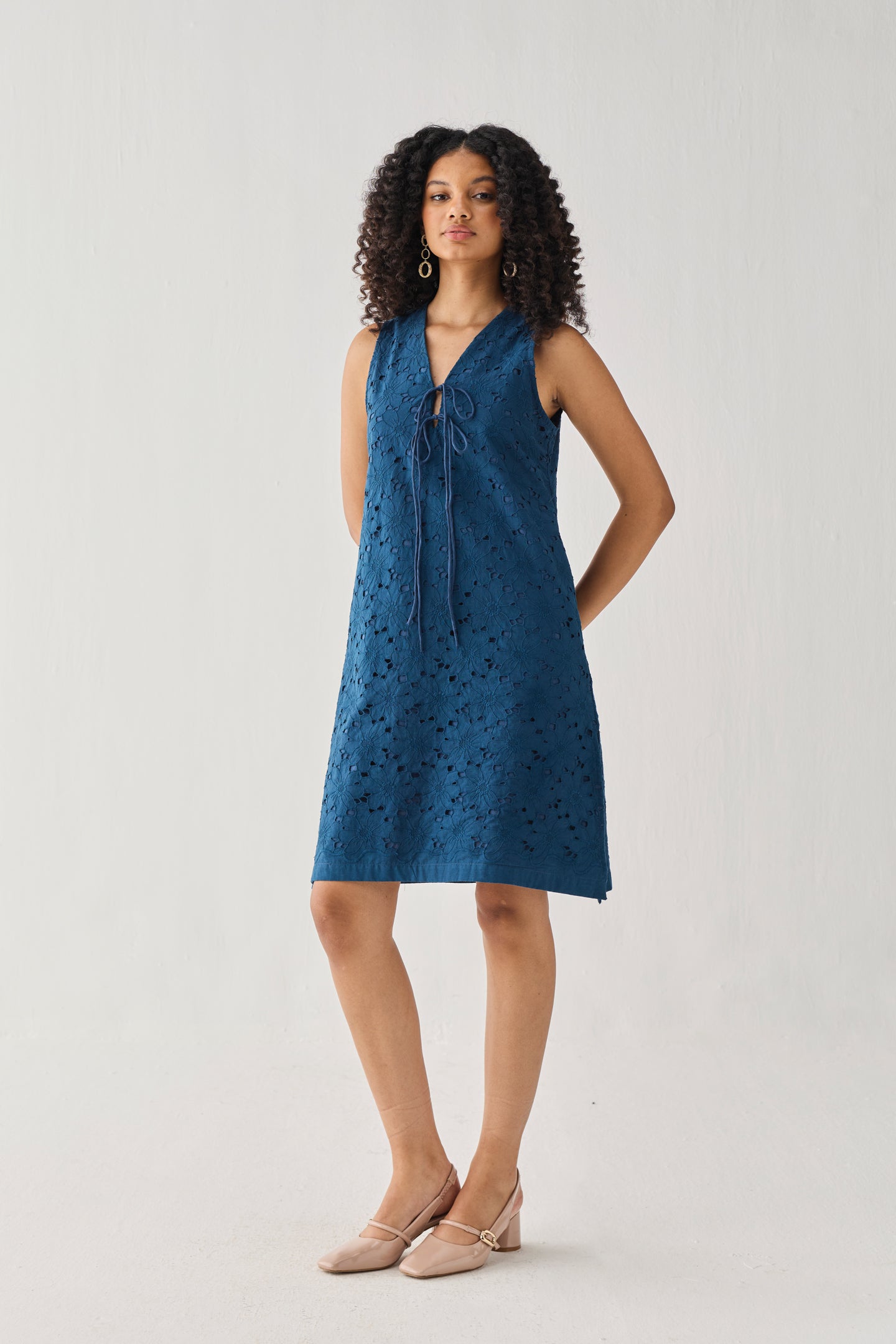 Woman wearing a blue dress with a white background