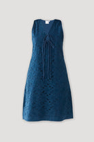 Sleeveless Knee-Length Dress in Blue featuring eyelet embroidery, a V-neckline with self-tie detail, and a relaxed A-line silhouette on a plain background.