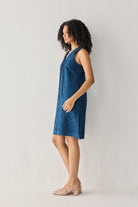 Sleeveless Knee-Length Dress in Blue featuring an all-over embroidered eyelet pattern, V-neckline, and relaxed straight silhouette, shown from the side in a full-length studio portrait with a lightweight, easy-to-wear design.