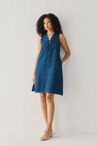 Sleeveless Knee-Length Dress in Blue with eyelet embroidery, V-neck tie detail, and a relaxed silhouette, shown in a full-length studio portrait.