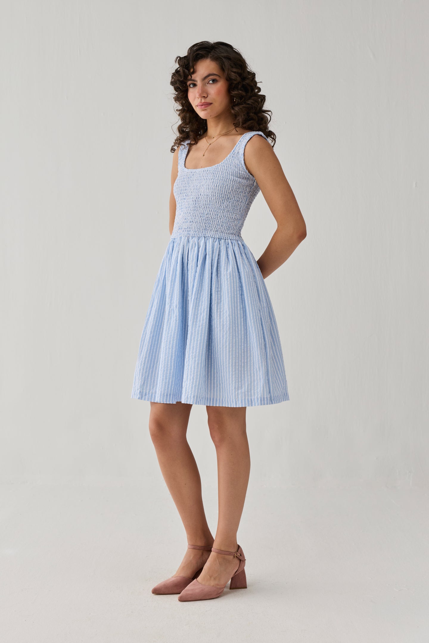 Smocked Short Dress in Blue Stripes combining a textured bodice, lightweight striped fabric, and a flattering silhouette for versatile fashion.