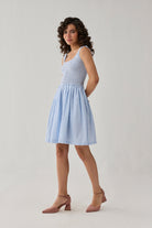 Smocked Short Dress in Blue Stripes showcasing a square neckline, gathered waistline, and airy skirt for timeless casual elegance.