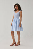 Smocked Short Dress in Blue Stripes showcasing a lightweight feel, elegant smocked detailing, and a relaxed skirt for everyday comfort.