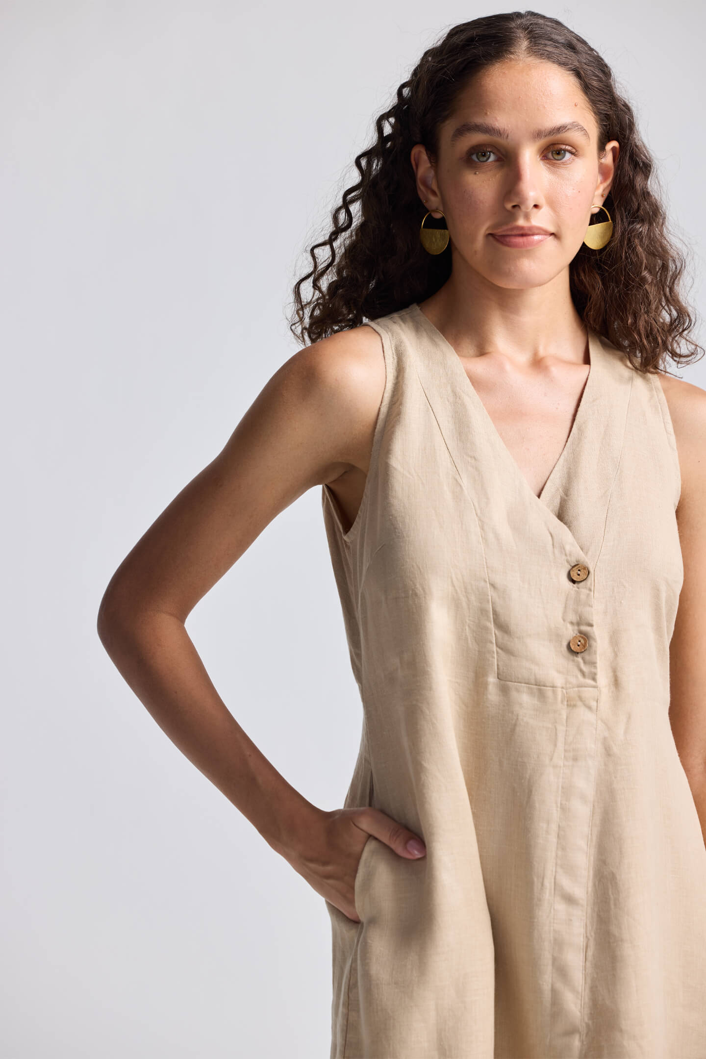 Straight Dress with Front Slit in Neutral Beige Hemp by Reistor, close-up view showcasing the sleeveless V-neck design, button-front detailing, and breathable sustainable fabric for women