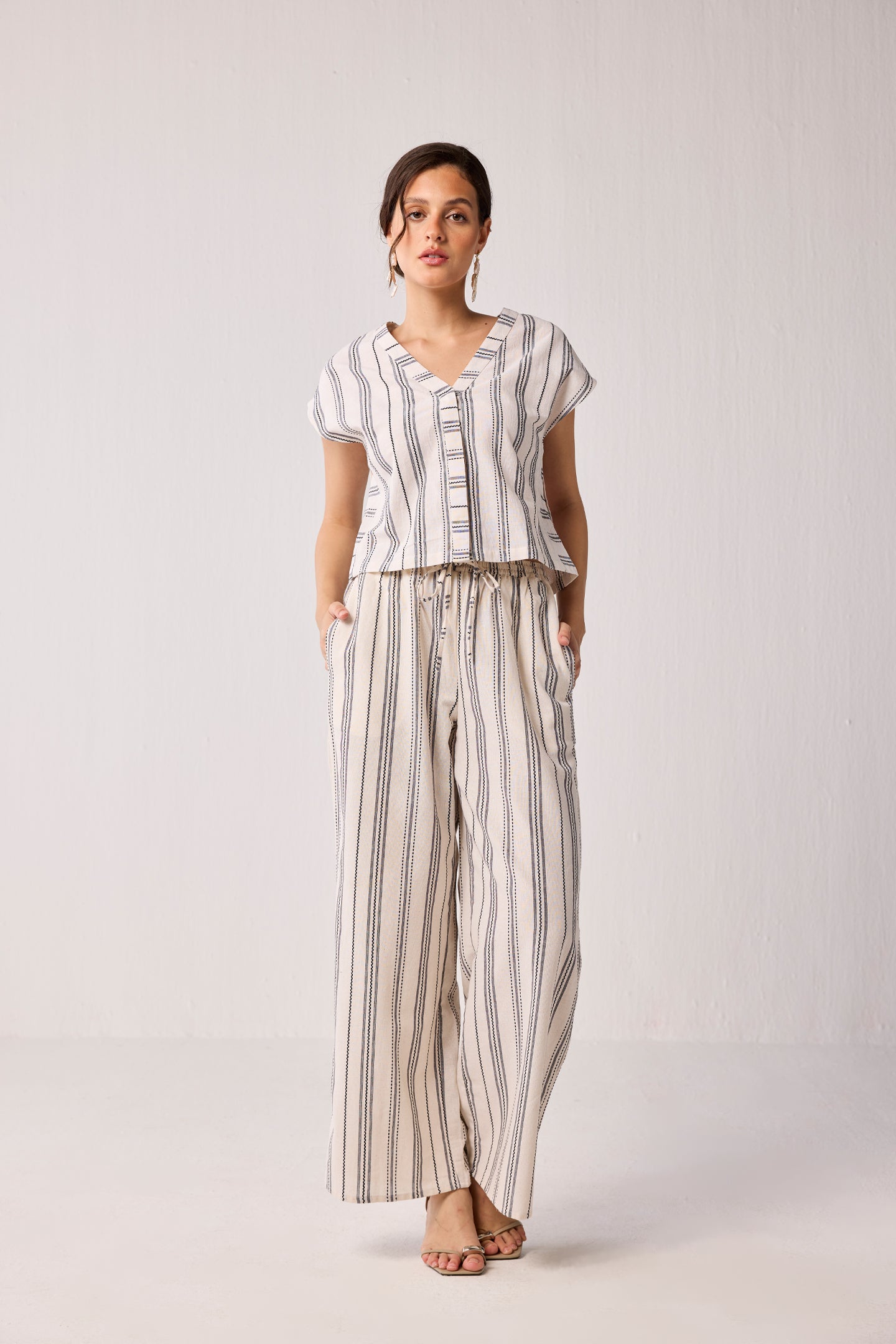 Full-length front view of Striped Matching Set with Wide-Leg Pants and V-neck Top for women, showcasing a relaxed-fit co-ord with vertical stripe pattern.