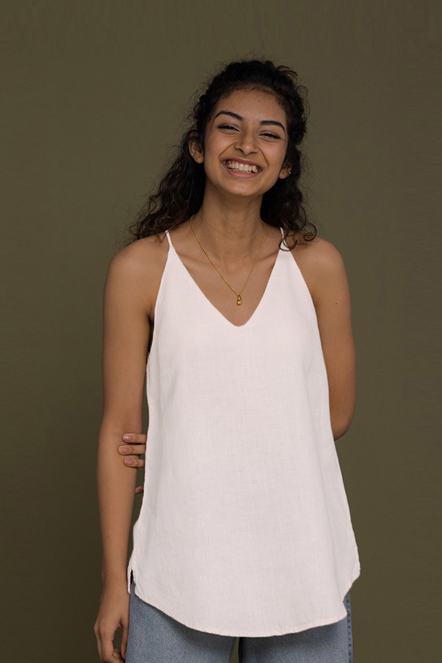 The Endless Sunday Top in White by Reistor, a lightweight sleeveless women's top with a relaxed fit, breathable fabric, minimalist style, and everyday comfort.
