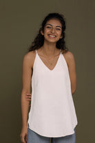 The Endless Sunday Top in White by Reistor, a lightweight sleeveless women's top with a relaxed fit, breathable fabric, minimalist style, and everyday comfort.