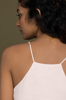 Back view of The Endless Sunday Top in White by Reistor, featuring delicate spaghetti straps, a relaxed fit, breathable fabric, and timeless minimalist style.