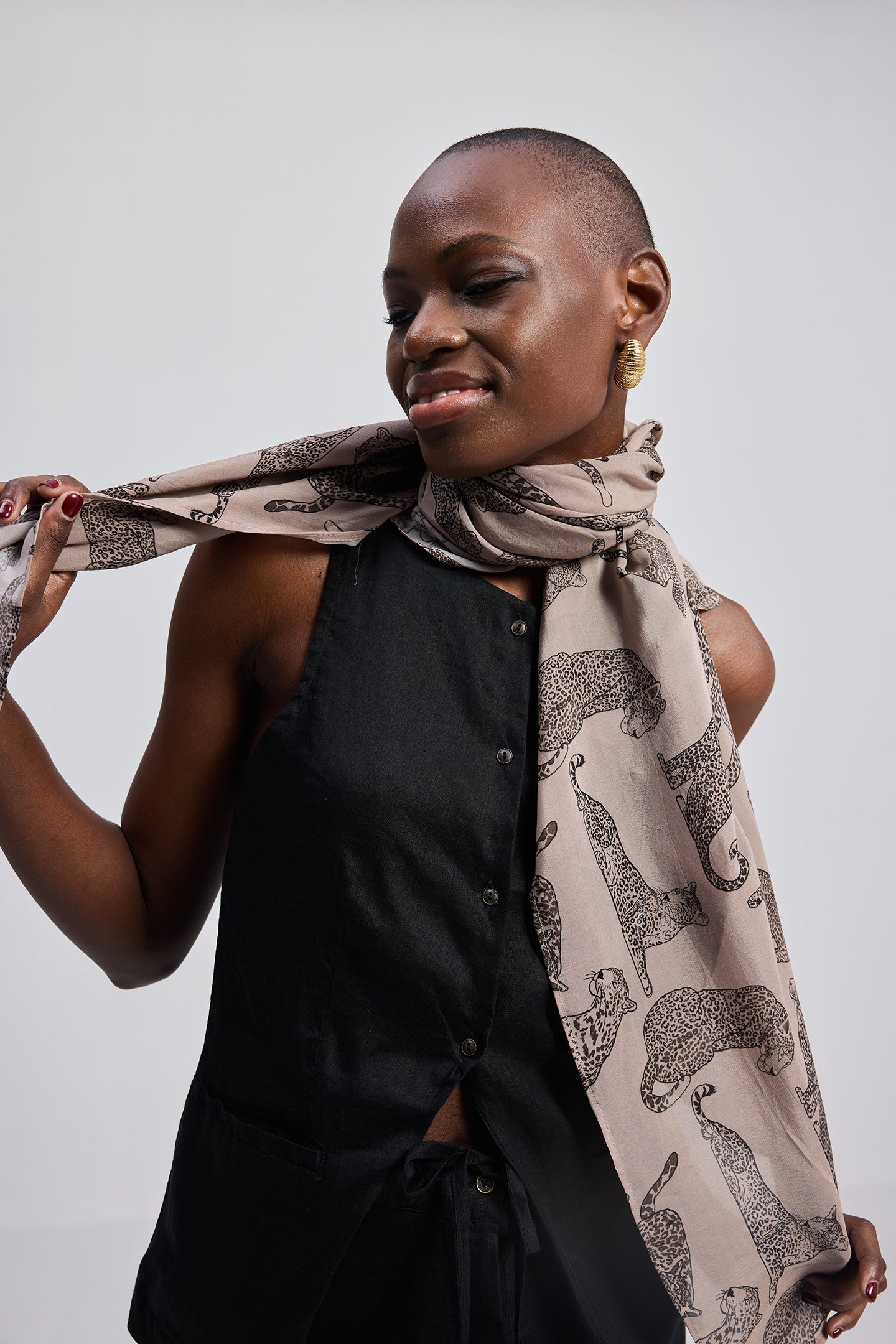 Woman wearing a patterned scarf with a plain background