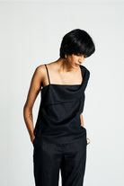 Reistor The Wandering Wave Top in Black, sustainable women's asymmetrical sleeveless top with breathable fabric, relaxed fit, and contemporary style.
