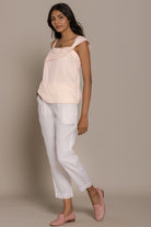 Reistor The Wandering Wave Top in Ice Pink styled for a relaxed vacation-ready outfit with easy charm.