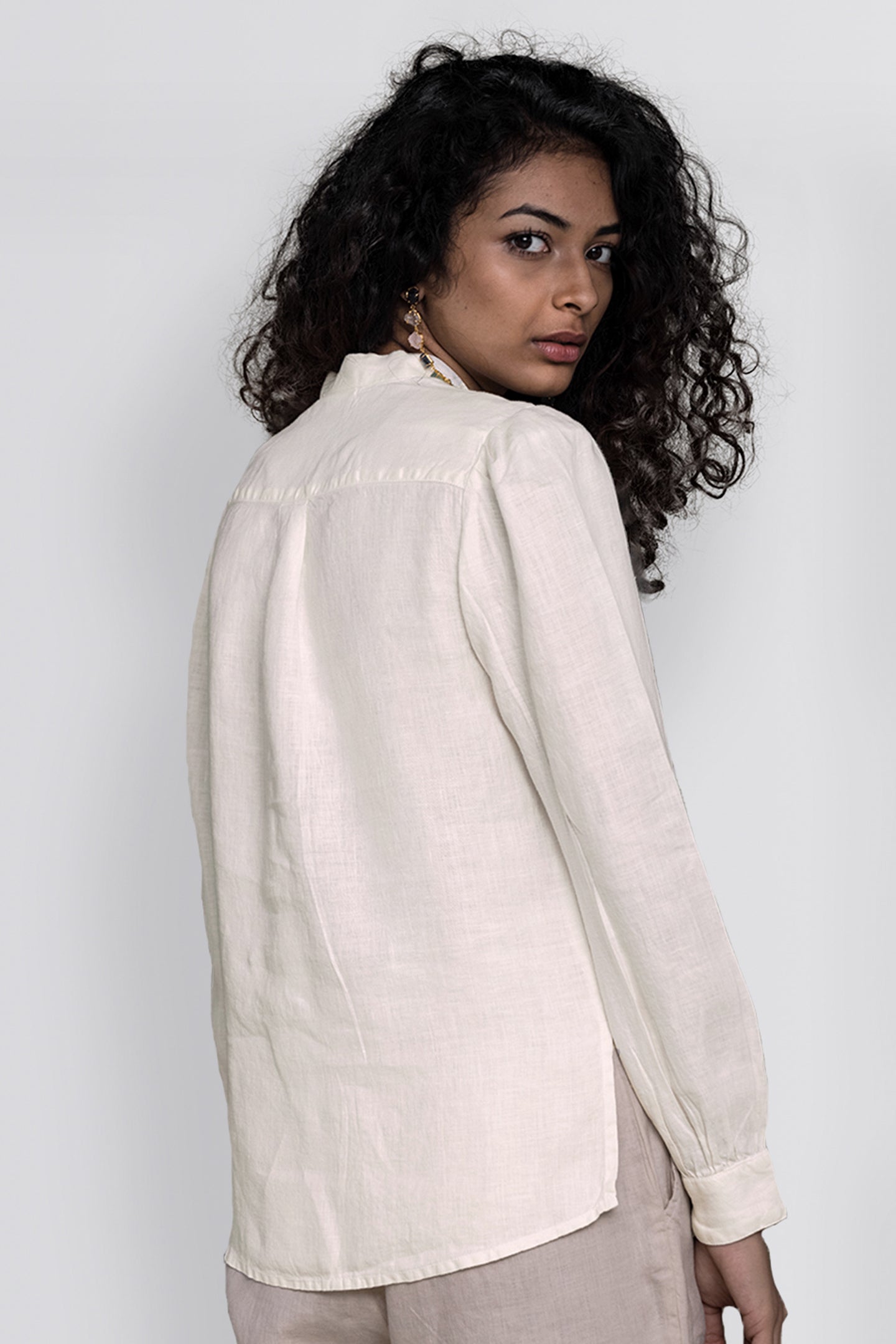 The Wild River Shirt in Off White by Reistor, crafted from breathable sustainable fabric with a relaxed fit, long sleeves, and a timeless minimalist design.