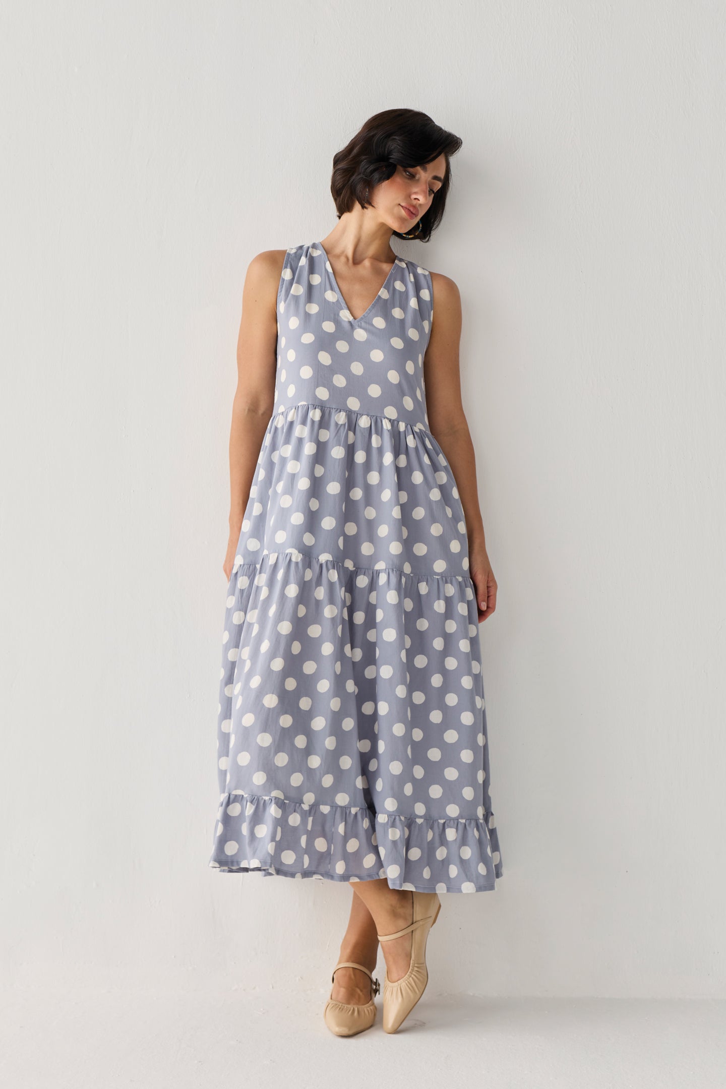 Tiered Midi Dress in Blue Polka showcasing a romantic silhouette with cascading tiers, oversized white dots, and an elegant lean that highlights its graceful drape.