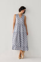 Tiered Midi Dress in Blue Polka showcasing a romantic silhouette with cascading tiers, oversized white dots, and an elegant lean that highlights its graceful drape.
