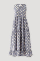 Sleeveless tiered midi dress in soft dusty blue featuring bold white polka dots, gathered layers, and a relaxed fit with elegant movement.