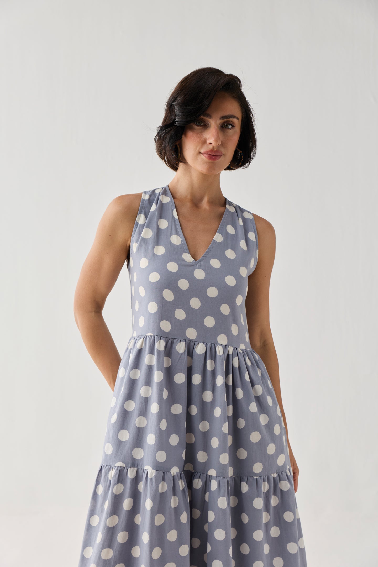 Sleeveless Tiered Midi Dress in Blue Polka with a relaxed fit-and-flare shape, bold white polka dots, and a flowing skirt designed for effortless movement.