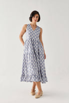 Tiered Midi Dress in Blue Polka with a softly gathered waist, oversized white dot print, and flowing layered skirt, styled in a relaxed full-length pose.