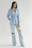 Full-length view of the Reistor Travel Light Denim Jacket in Ocean Blue, featuring a drawstring waist, lightweight denim fabric and relaxed everyday style.