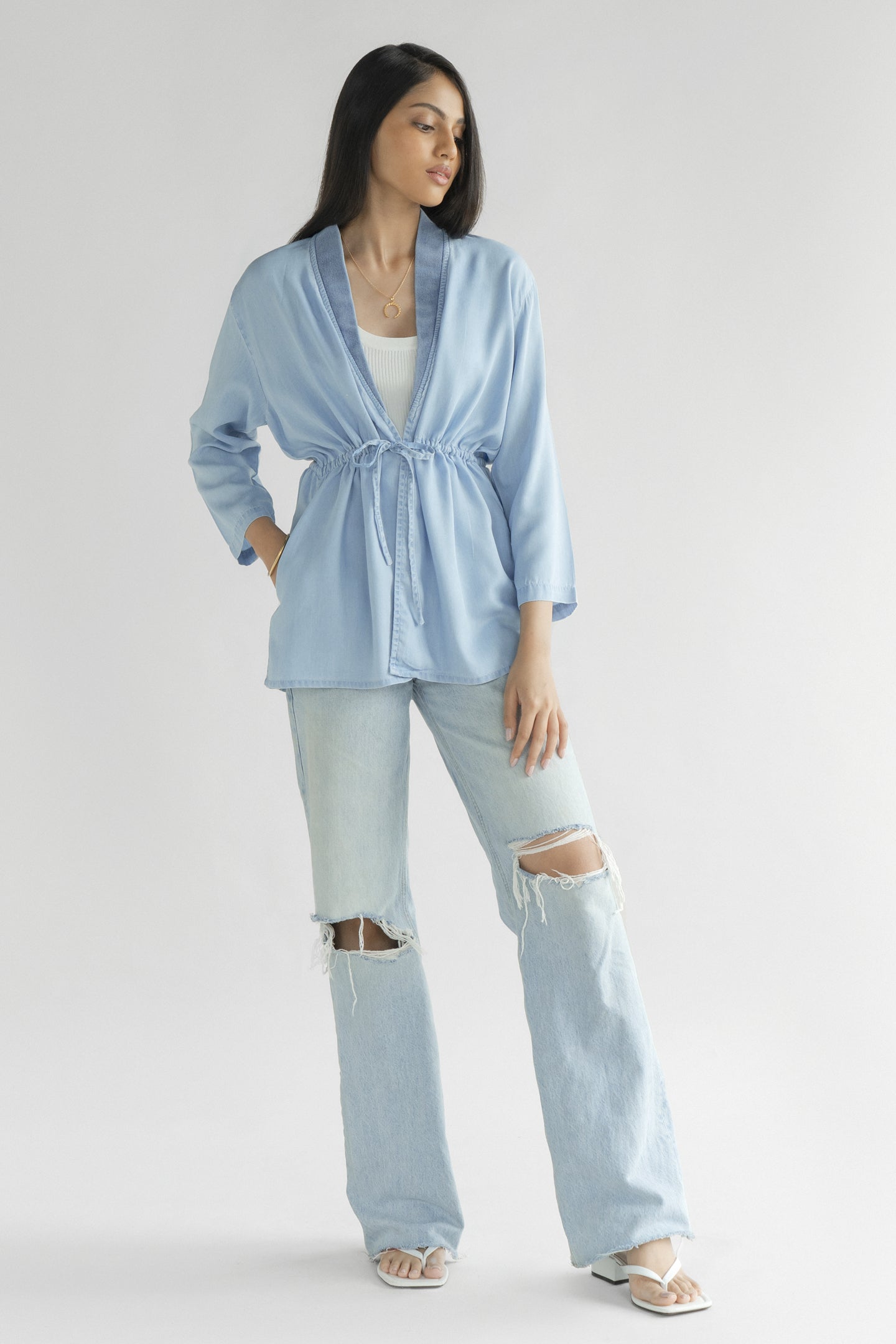 Full-length view of the Reistor Travel Light Denim Jacket in Ocean Blue, featuring a drawstring waist, lightweight denim fabric and relaxed everyday style.
