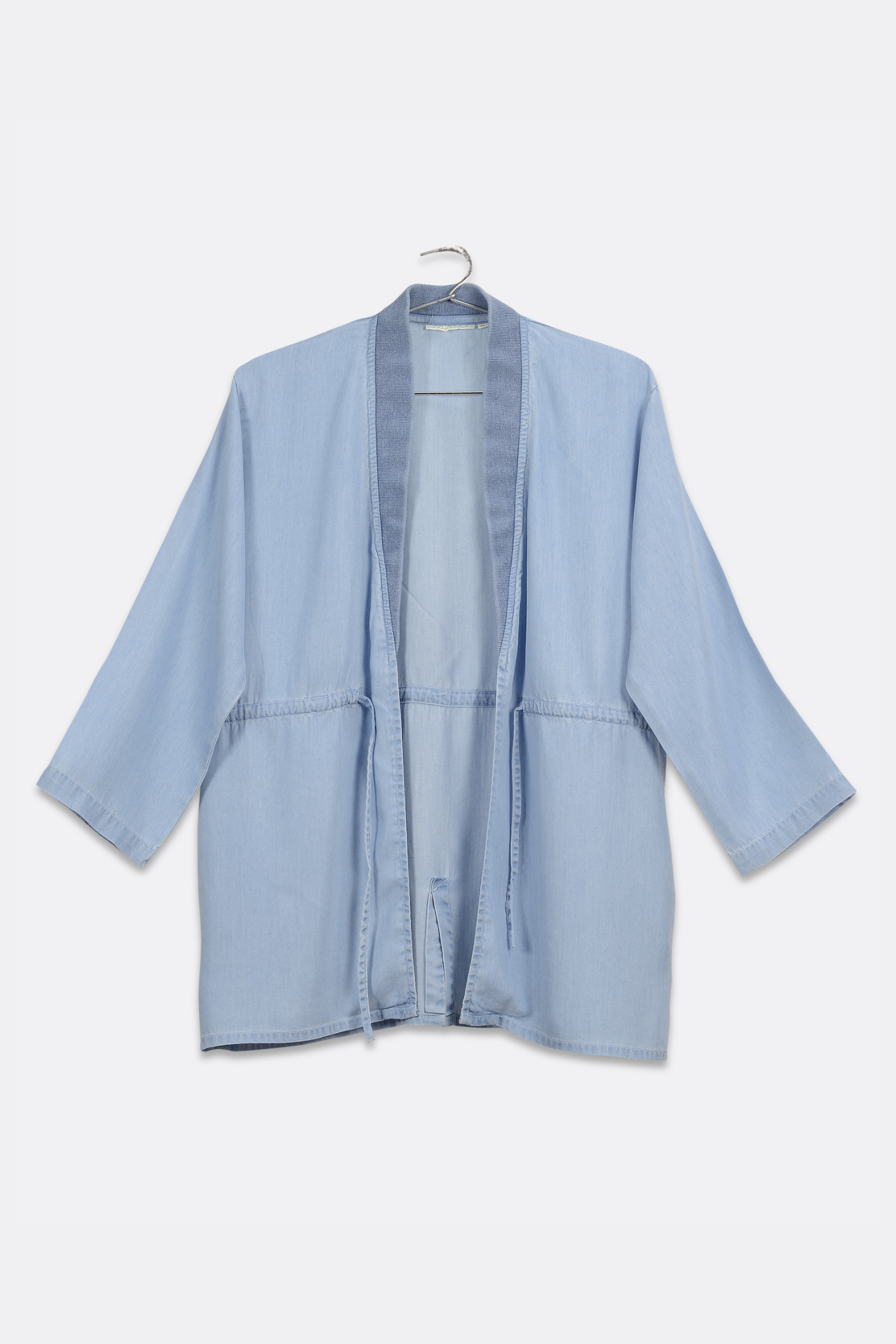 Light blue jacket on a hanger against a white background
