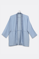 Light blue jacket on a hanger against a white background