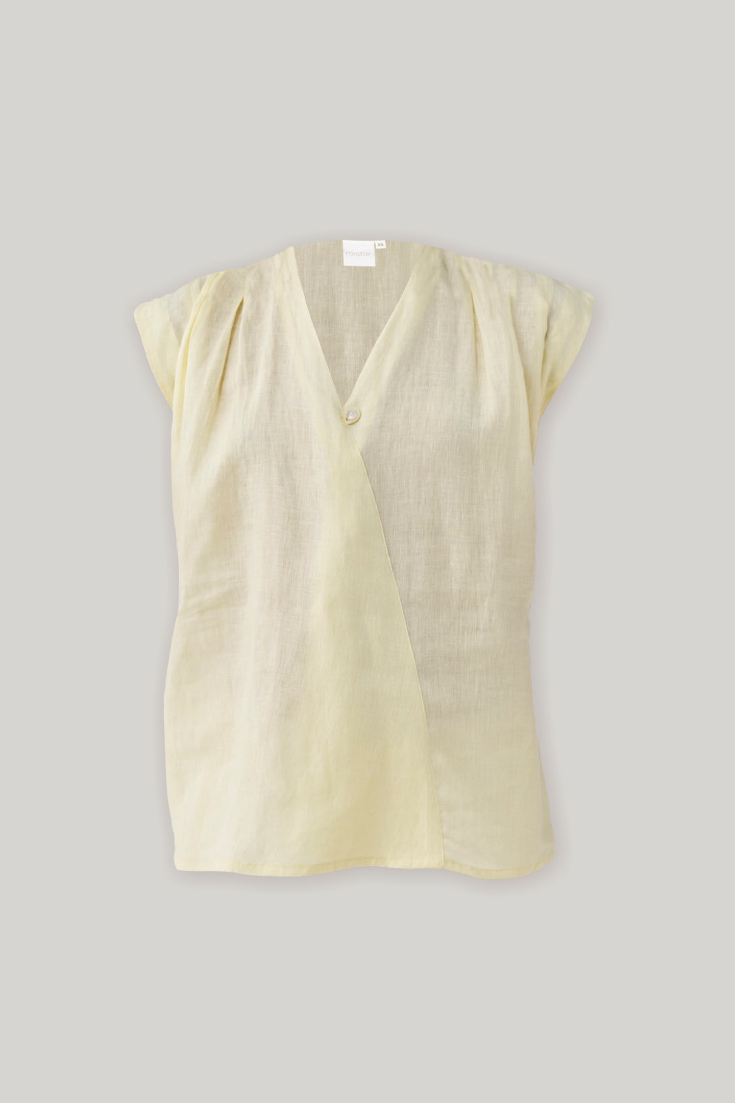Flat lay of Reistor's V-neck Overlap Top in Butter Lemon, showcasing its elegant overlap neckline, cap sleeves, and relaxed silhouette.