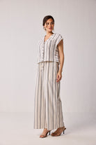 Model wearing Reistor Wide-leg Drawstring Pants in Stripes, featuring a relaxed wide-leg silhouette with vertical striped pattern and drawstring waist.