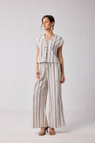Reistor Wide-leg Drawstring Pants in Stripes – model wearing striped wide-leg drawstring pants with matching top, comfortable casual outfit