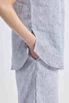 Model wearing grey Wide Leg Linen Pants by reistor with a matching striped linen shirt set.
