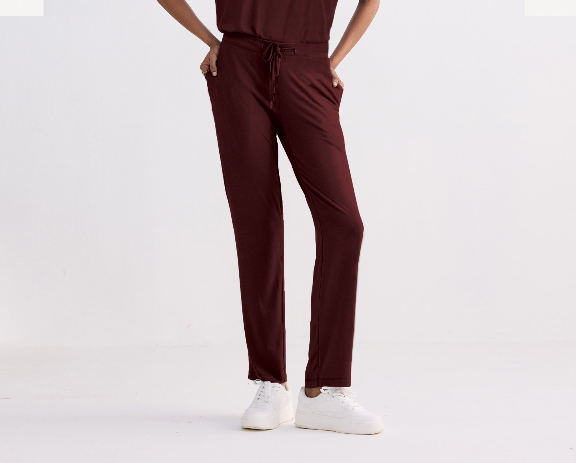 Merlot pants worn by a person on a white background