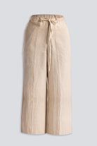 Close-up of Reistor Wide Leg Pants in Hemp, highlighting the soft textured hemp fabric, adjustable drawstring waist, and relaxed sustainable design in a natural beige shade.