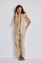 Model wearing reistor Wide Leg Pants in Hemp styled with a matching sleeveless vest, featuring a relaxed wide-leg silhouette, natural beige tone, and sustainable hemp fabric.