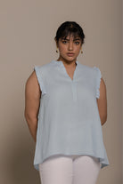 Reistor Wind in my Hair Shirt in Blue with soft ruffle sleeves, breezy sustainable fabric and a relaxed fit for women