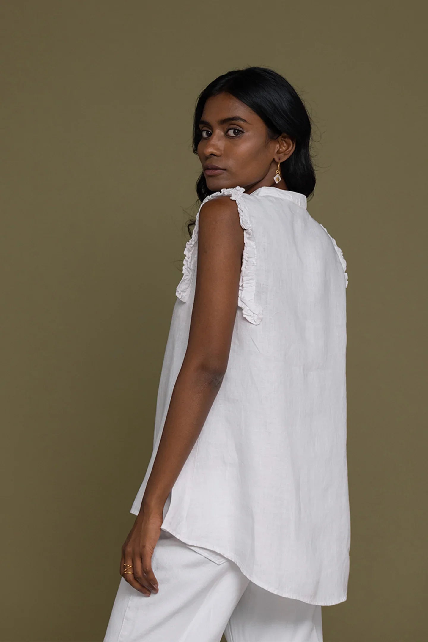 Reistor Wind in my Hair Shirt in White for women, angled back view with ruffle sleeves and a breezy relaxed fit
