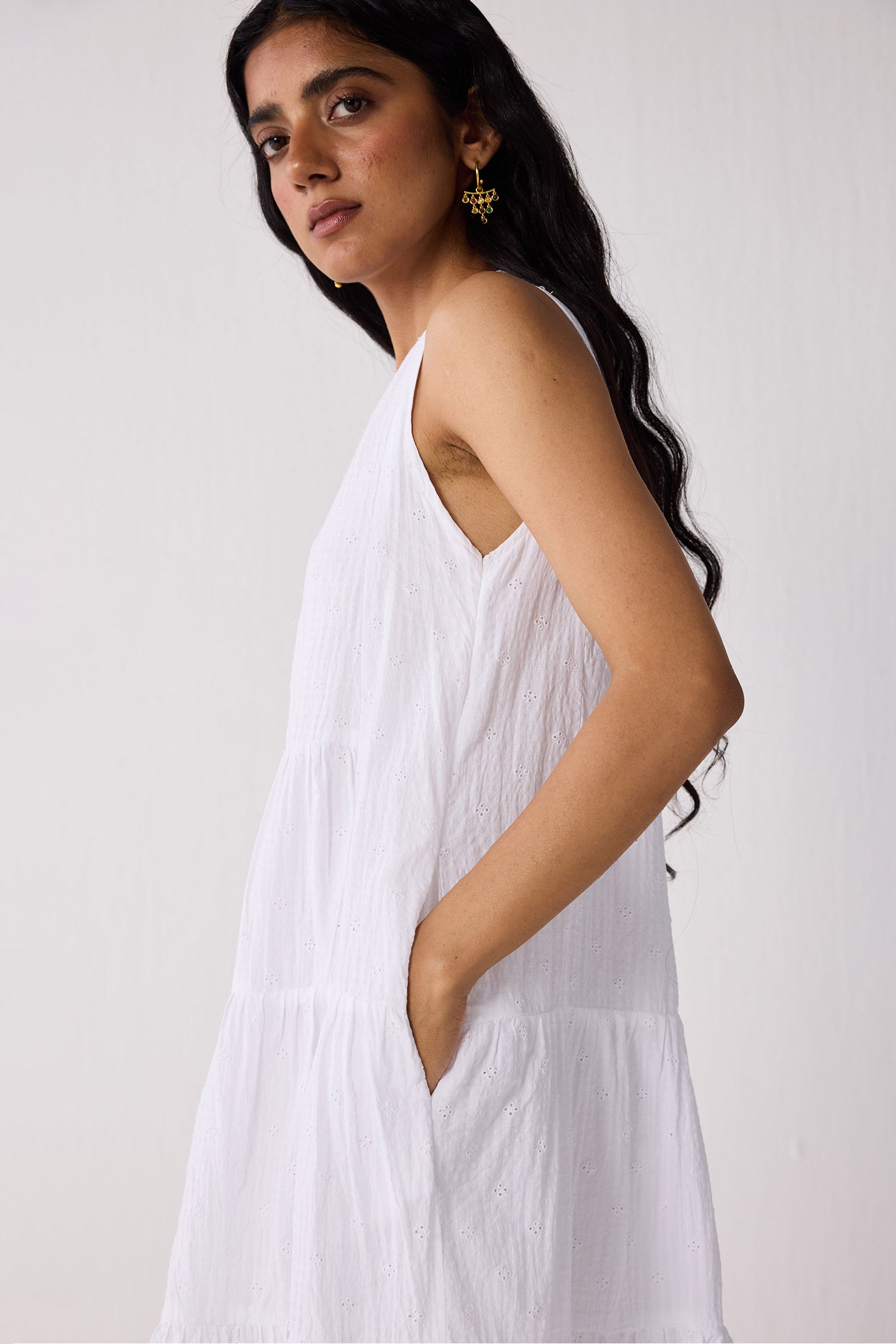 Woman wearing a white dress against a plain background