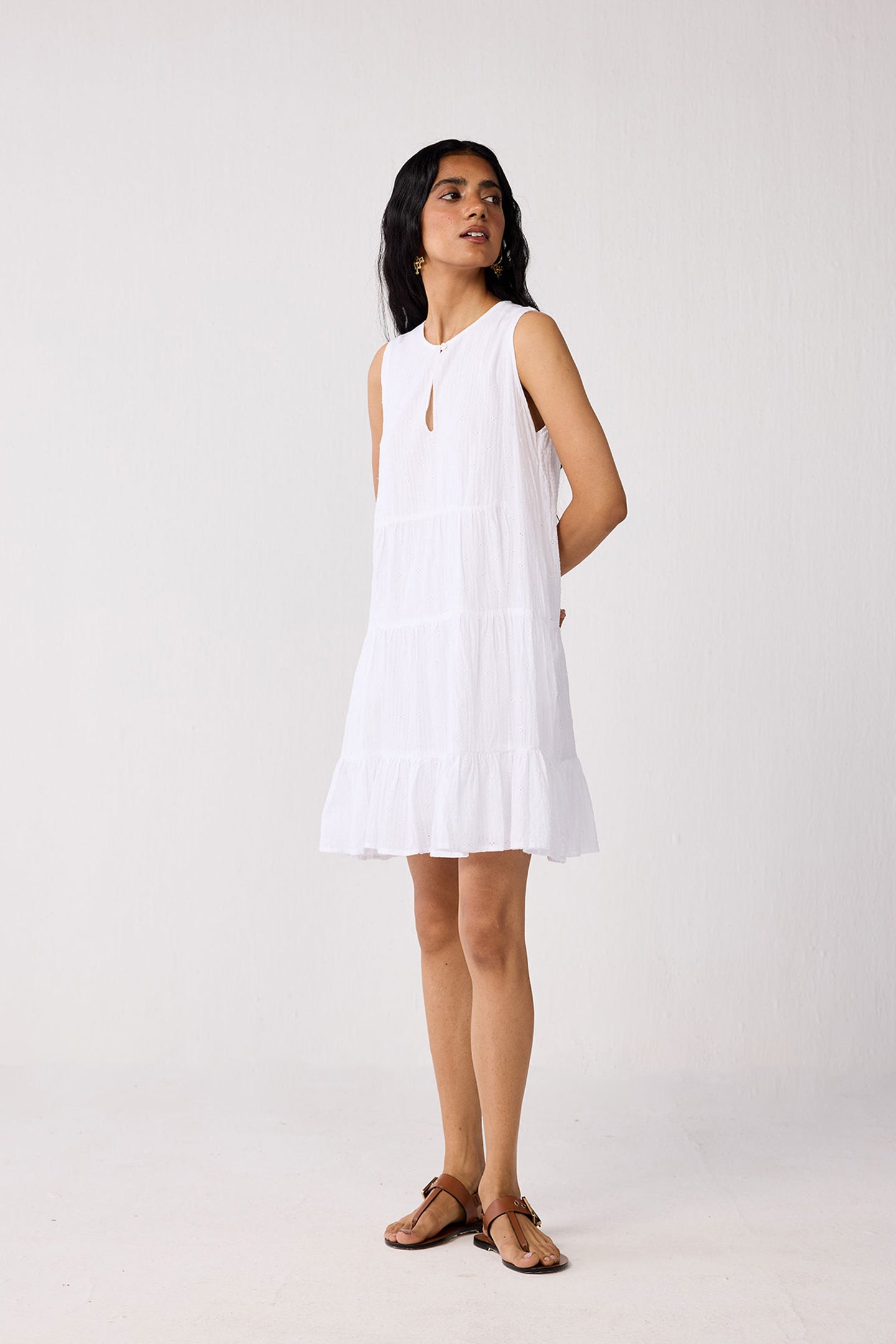 Woman wearing a white dress against a plain background