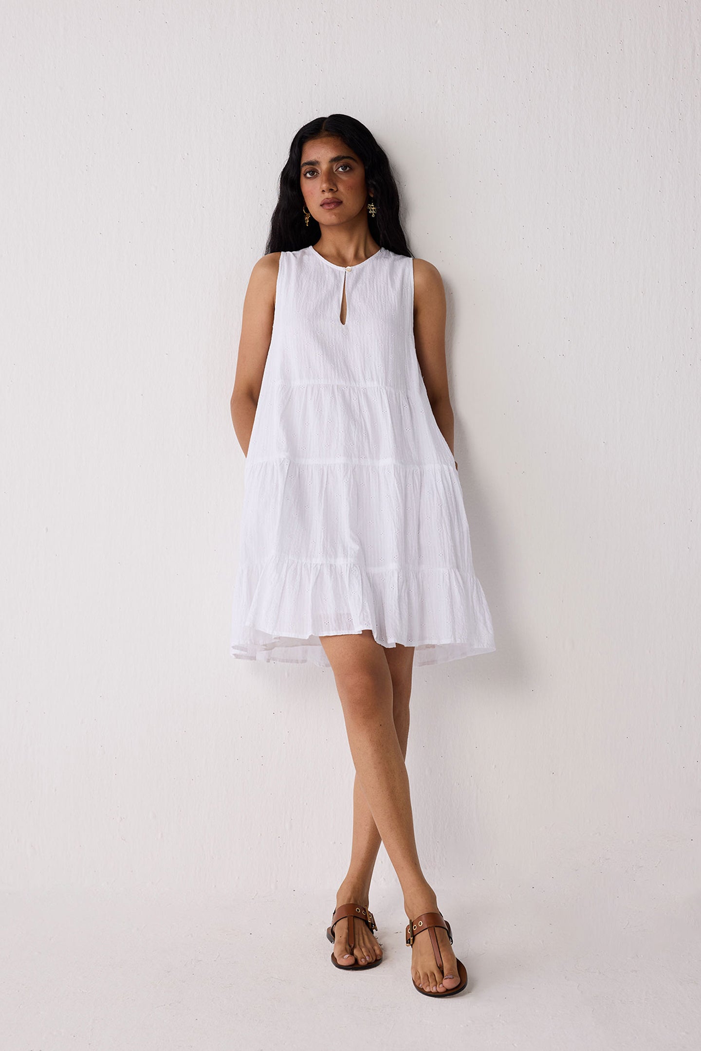 Woman wearing a white dress against a plain background