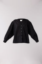 Black button-up shirt on a light gray background