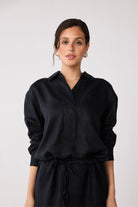 Woman wearing a black dress against a white background