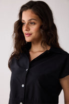 Woman wearing a black shirt against a white background