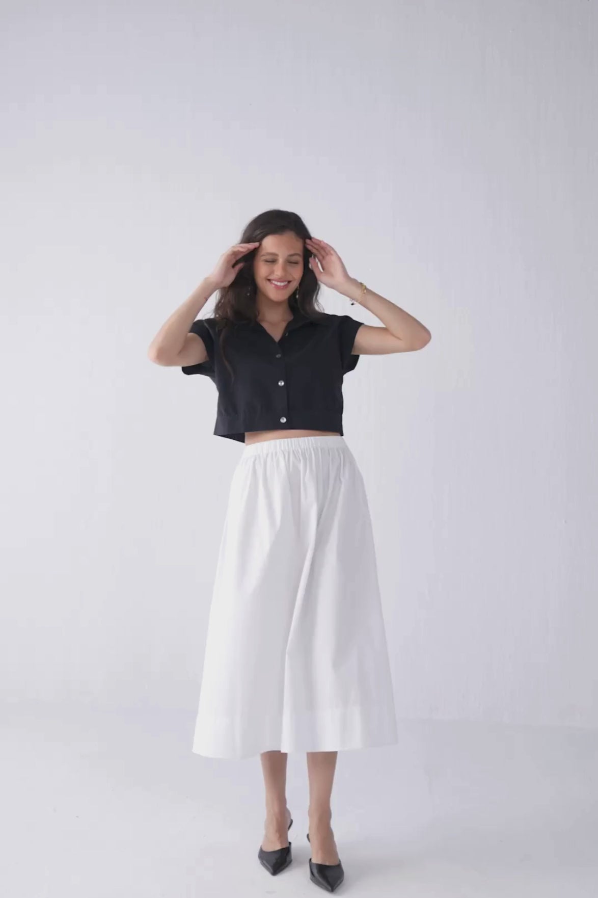 Model styling Reistor Oversized Crop Shirt in Black with varied poses and back angle, including close-ups that highlight the structured collar, cropped hemline, and effortless oversized shape.