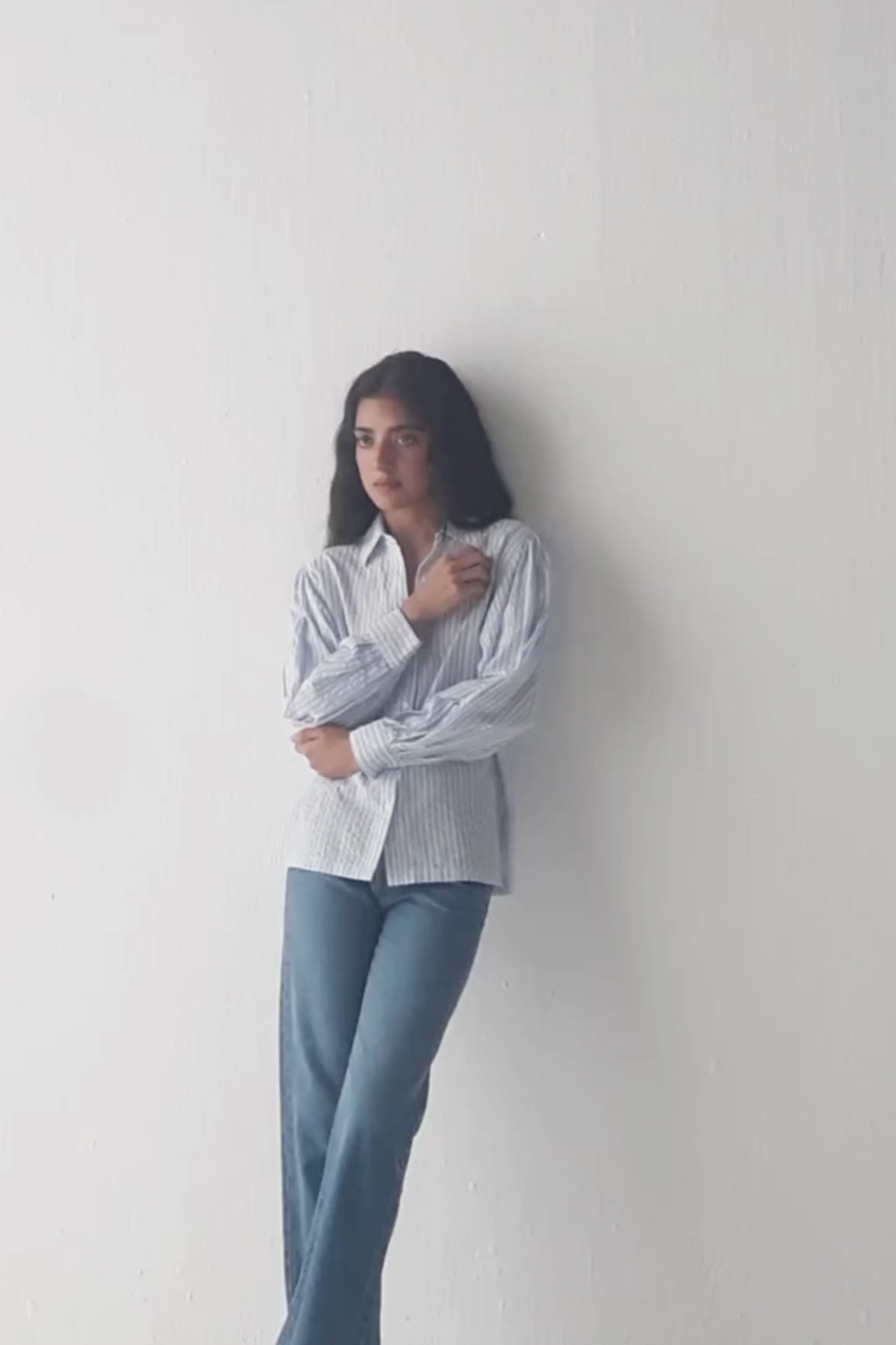 Model showcases the reistor Striped Shirt with Long Balloon Sleeves in Blue through varied poses and close-ups, emphasizing the classic striped pattern, gathered balloon sleeves, cuff detailing, and lightweight, breathable fabric.