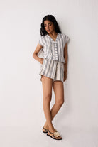 Woman wearing a striped outfit against a white background