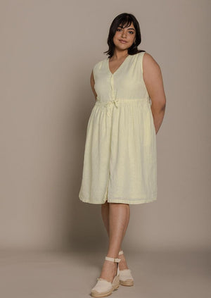 mid length functional yellow sleeveless dress with a drawstring on the waist to give it more definition. 