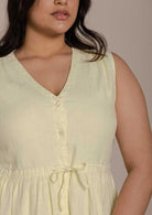 mid length functional yellow sleeveless dress with a drawstring on the waist to give it more definition. 